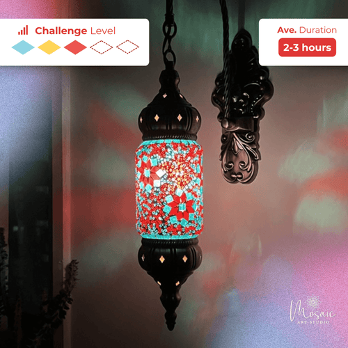 Colorful mosaic hanging lantern with red, blue, and white patterns glowing on a wall