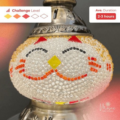 Close-up of a mosaic lamp with white, red, yellow, and black glass beads and metal fixture, DIY challenge level and duration shown