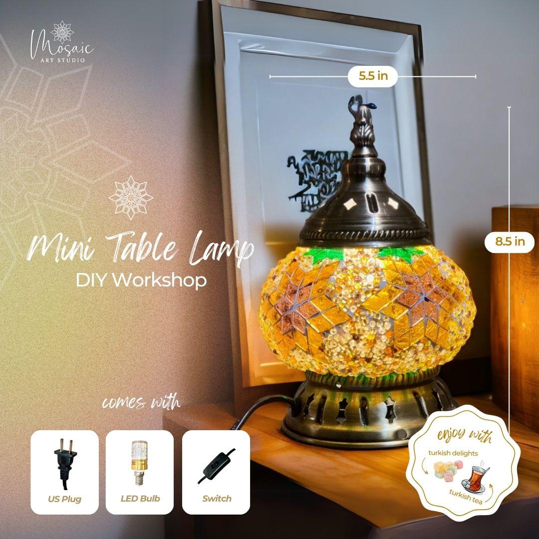 Mini Turkish mosaic table lamp with amber glass design, bronze metal top, and base on wooden surface