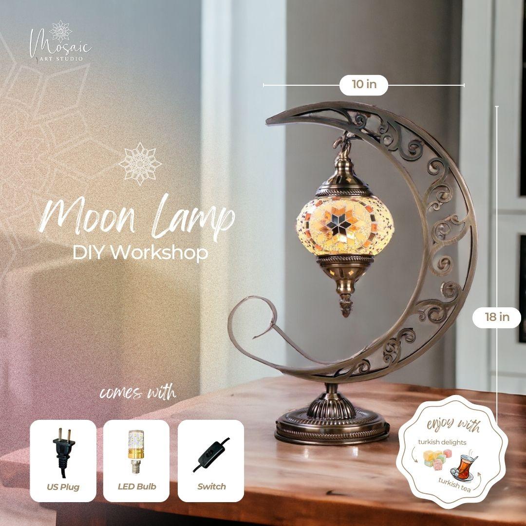 Decorative moon-shaped metal stand lamp with mosaic glass lantern on wooden table