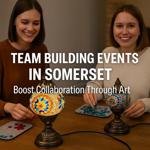 Two women smiling while creating mosaic art with colorful lamps during a Somerset team building event