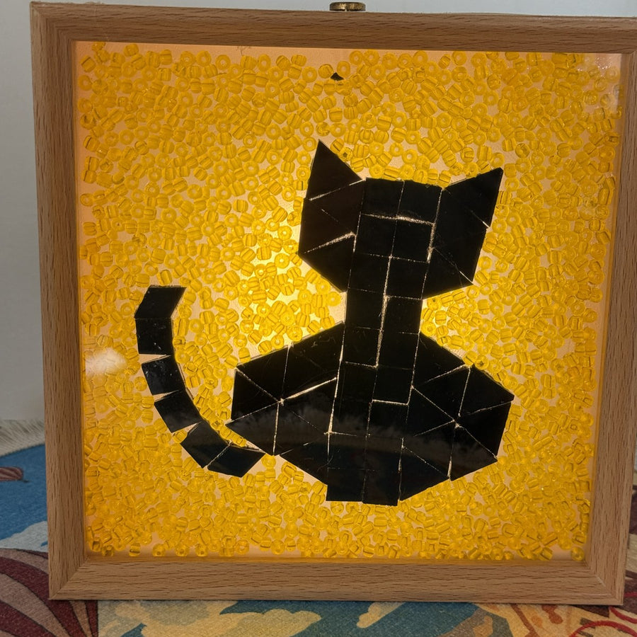 Handmade Halloween black cat mosaic light box glowing with amber glass beads in a wooden frame