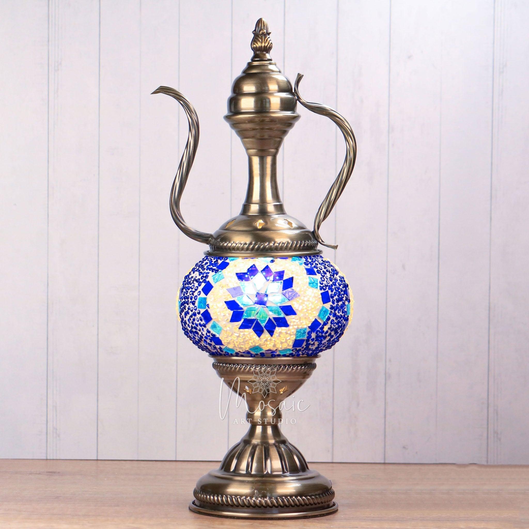 Turkish mosaic lamp with blue and white stained glass and antique brass metal base on wooden table