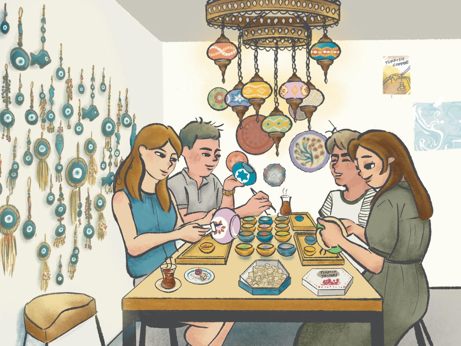 Four people painting decorative ceramics at a table with Turkish tea and sweets in a cozy art studio