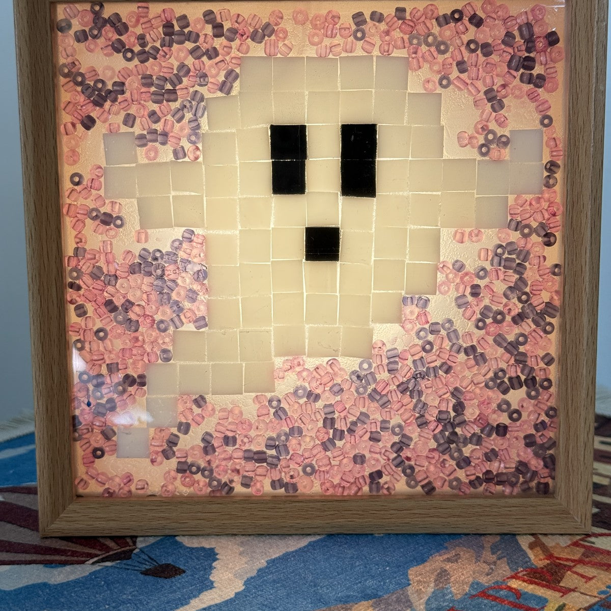 Handmade Halloween ghost mosaic light box with a cream glass ghost on pink and plum beads in a wooden frame