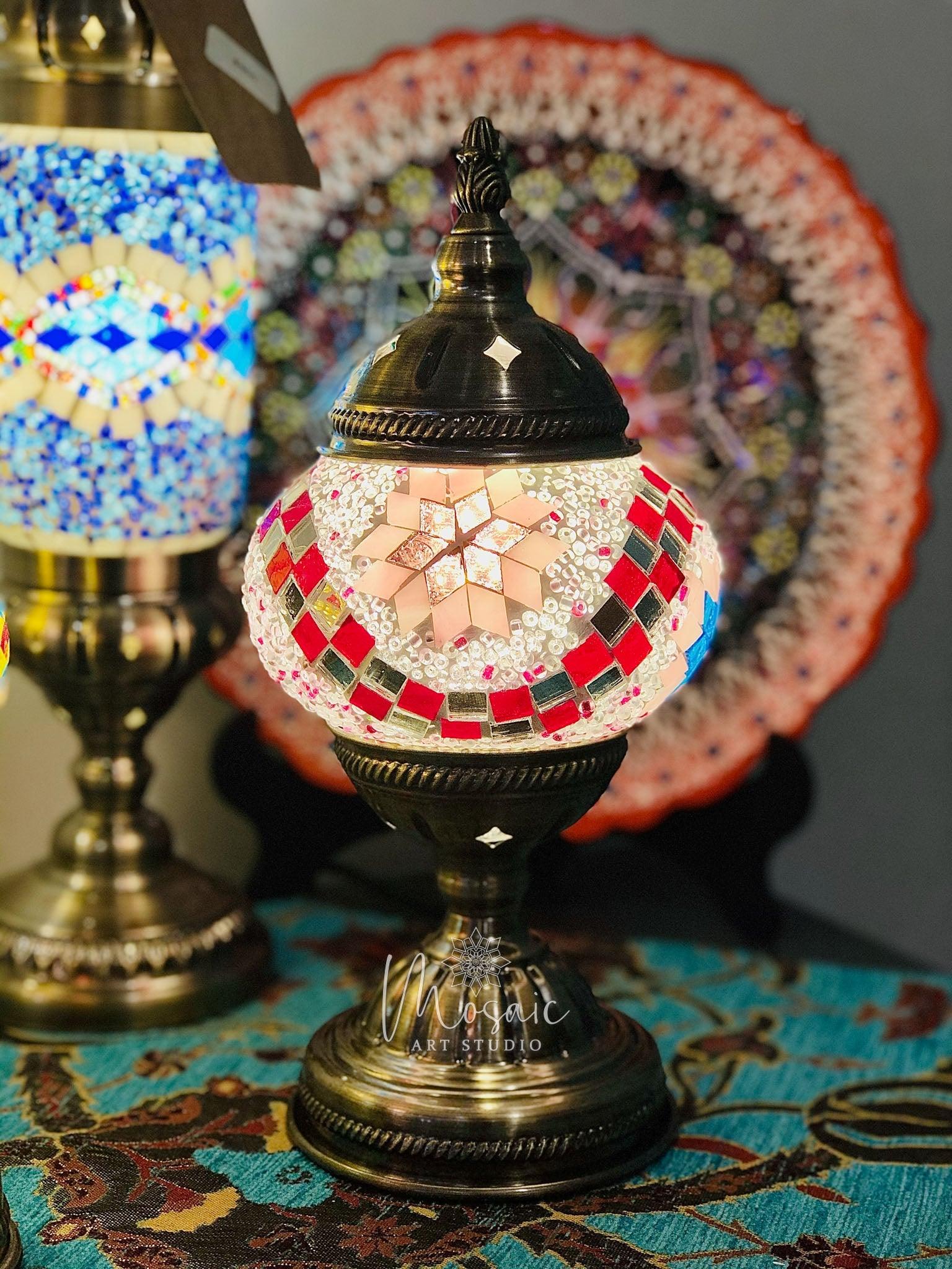 Turkish mosaic table lamp with star pattern in red and white tiles on brass base, colorful mosaic backdrop