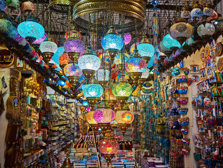 Colorful mosaic glass lanterns hanging in a vibrant Middle Eastern market shop filled with souvenirs