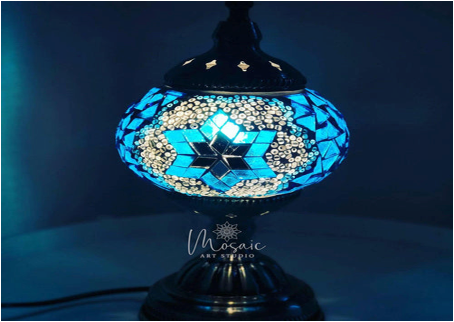 Blue and white mosaic table lamp with geometric star pattern on dark base