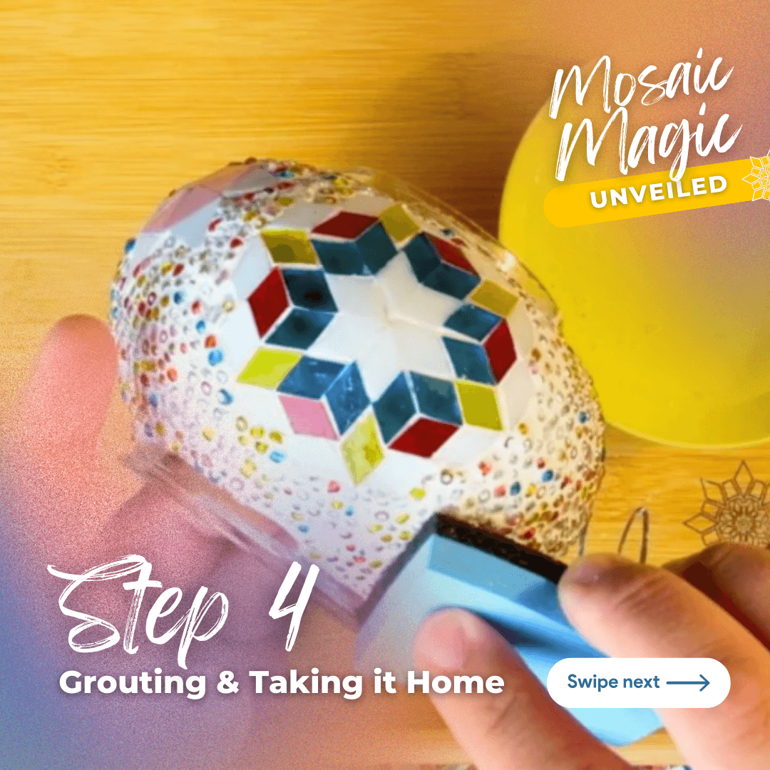 Hand applying grout to colorful mosaic art piece on wooden surface in mosaic studio