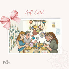 Illustration of four people painting ceramics at a decorated table with hanging lanterns and wall art, gift card design