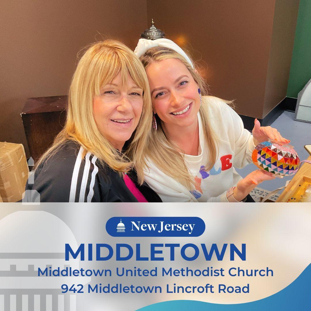 Two smiling women indoors holding a colorful mosaic craft at Middletown United Methodist Church, New Jersey