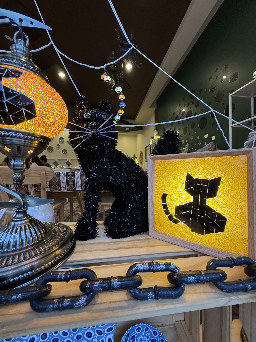 Black cat mosaic lamp and light box in a Halloween window display