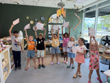 Group of young students holding up their completion certificates at the end of a session