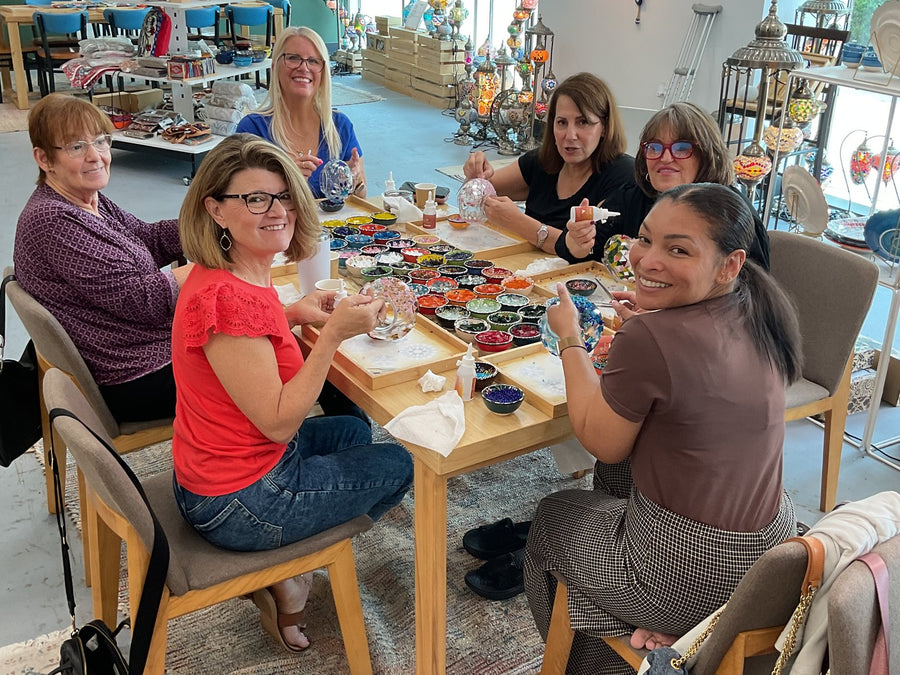 A group making mosaic lamps by the windows at Mosaic Art Studio in Voorhees, NJ