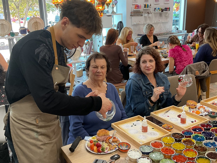 An instructor helping guests with their mosaic lamps at the Voorhees, NJ studio