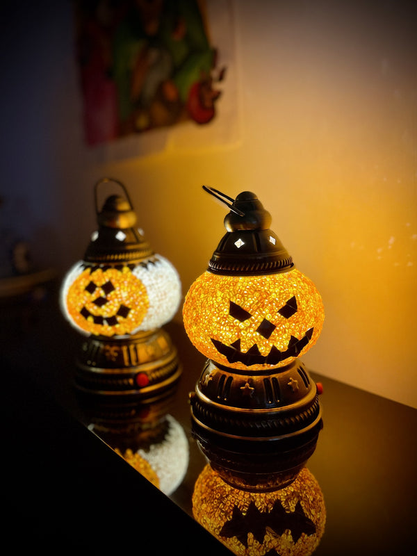 Jack-o'-lantern faces in amber. Handmade with love at a Mosaic Art Studio workshop.