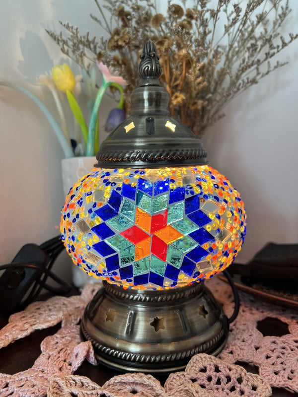 Red star on a deep blue sunburst. Handmade with love at a Mosaic Art Studio workshop.