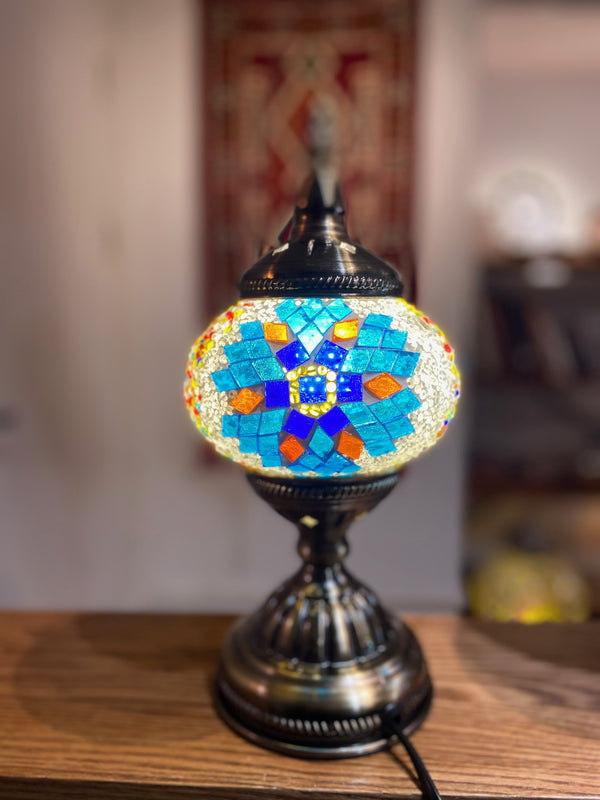 Sky-blue flower with orange petals. Handmade with love at a Mosaic Art Studio workshop.
