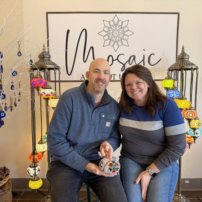 Couple on a date night holding their mosaic lamps