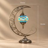 Turkish mosaic moon lamp with the globe suspended inside a scrolled crescent stand, 10 by 18 inches