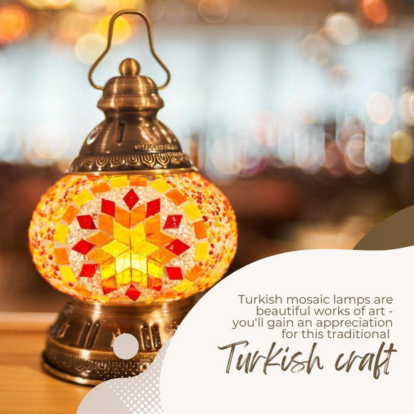 Close-up of a colorful Turkish mosaic lamp with warm yellow, orange, and red glass pieces in a brass holder