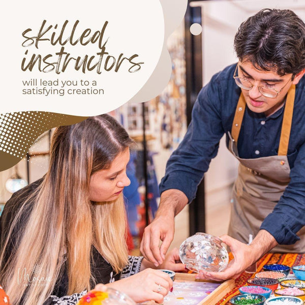 Mosaic art instructor guiding a woman in mosaic creation at art studio workshop