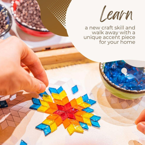 Hands assembling colorful glass mosaic tiles in a star pattern at a mosaic art workshop