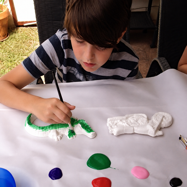 Camper painting a plaster sculpture at the Mosaic Art Studio summer camp Plaster workshop