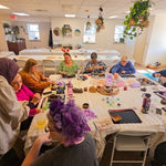 Group of participants crafting wire trees together during a workshop session in King of Prussia, PA