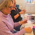 Participant shaping pink beaded branches during the Wire Tree Art Workshop in King of Prussia, PA