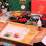 DIY Christmas mosaic candle holder kit with colorful tiles, glass holder, glue, and instructions